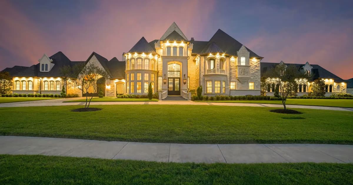 Large home with an illuminated stone exterior